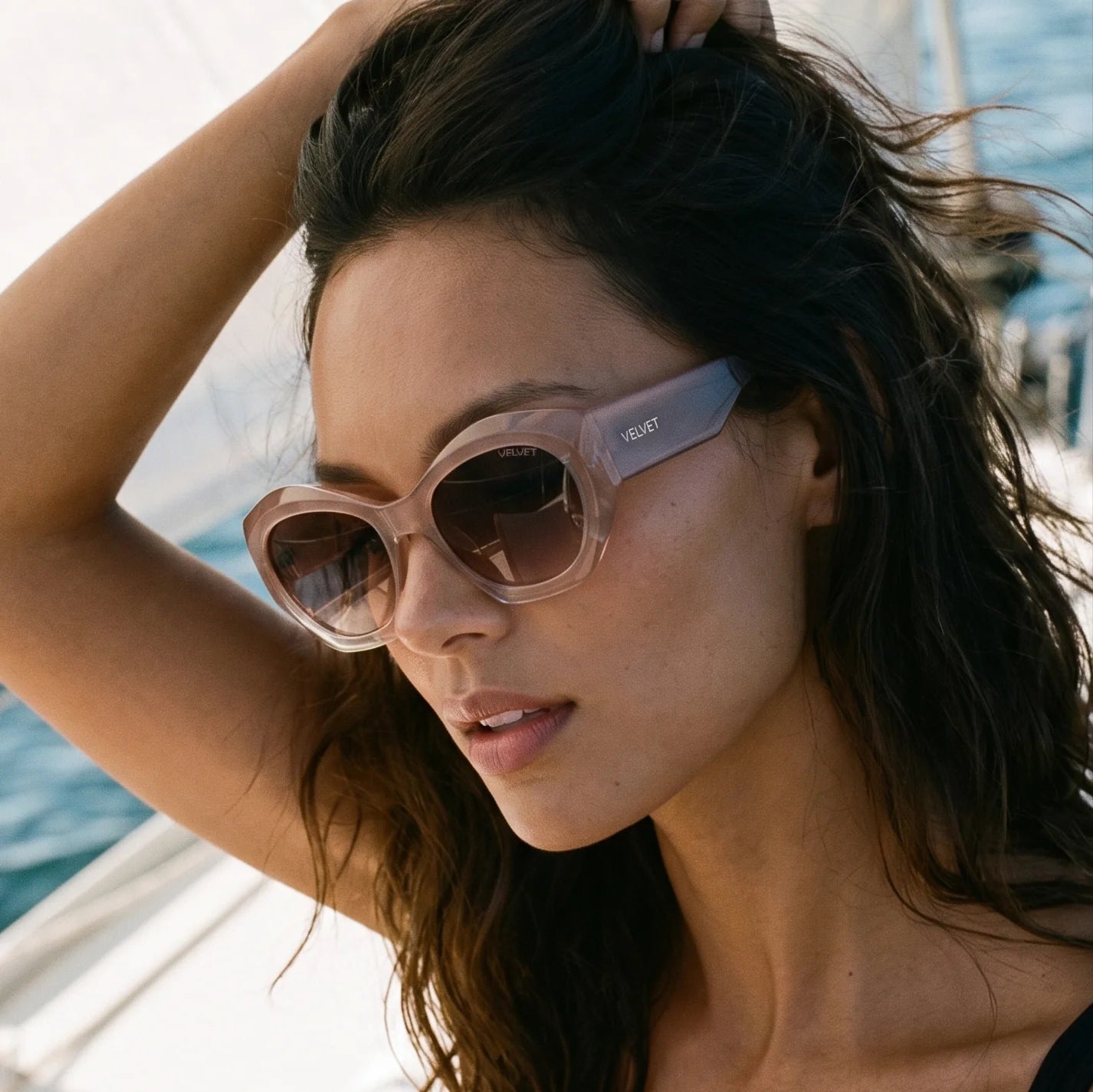 Alice polarized oversized cat eye sunglass style for Women by Velvet Eyewear. Best for Oval, Square and Heart Face Shapes. Best for seasonal color palettes Spring, Summer and Fall. Worn by our model Rocky on a sailboat