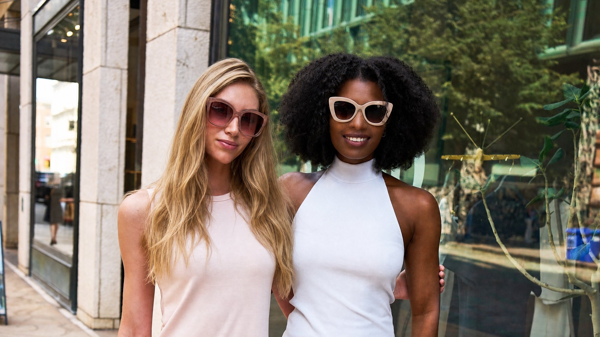 Two models wearing Velvet Eyewear® sunglasses: Jane in Blush and Maya in Beige cat-eye. Find your most flattering frames with the original Shop By Face Shape guide by Velvet Eyewear®.