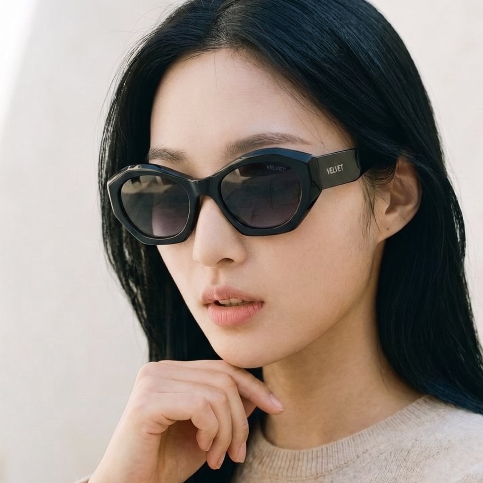 Black cat eye polarized sunglass style Alice by Velvet Eyewear. Designed for Oval, Square, and Heart Face Shapes. Great for all seasonal color palettes. Model photo.