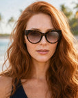 Chelsea for Women by Velvet Eyewear. Best for Oval, Square, and Heart Face Shapes. All Seasonal Palettes. Worn by our model Sarah near the beach.