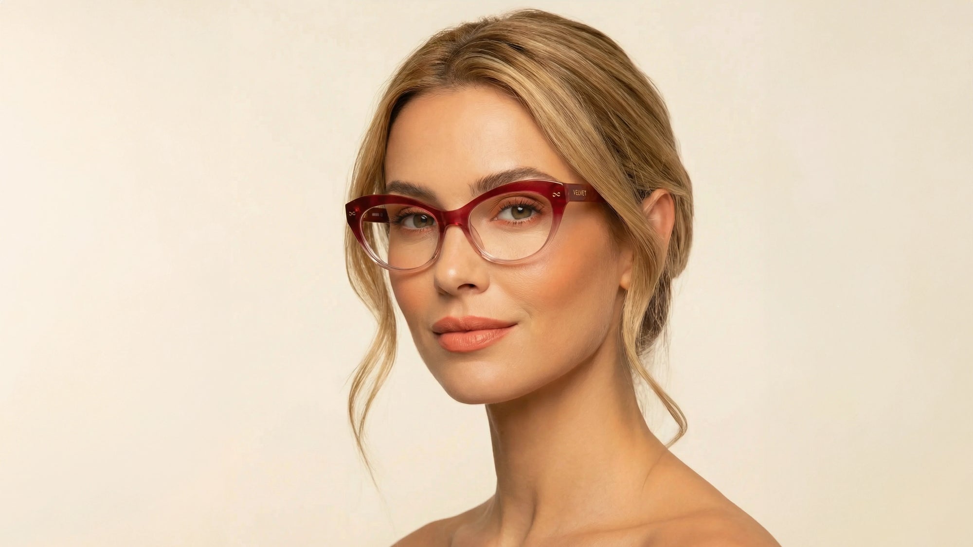 Woman wearing Velvet Eyewear Minnie red cat-eye optical frames, ideal for a heart face shape.
