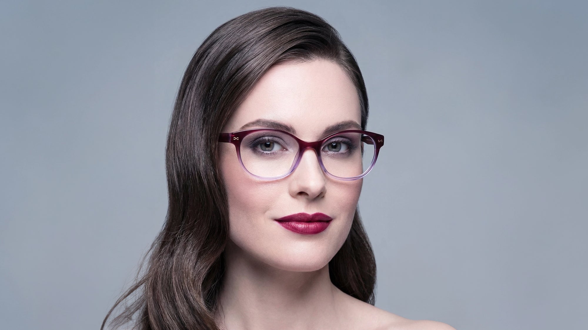 Woman wearing the Joan optical frames in plum by Velvet Eyewear, designed for a square face shape
